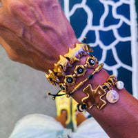 Gold bracelets with black adjustable cord