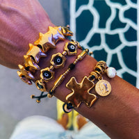 Gold bracelets with black adjustable cord